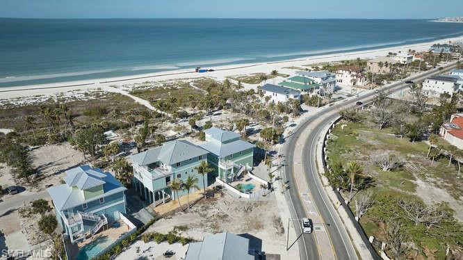Drone / aerial view featuring a beach view and a water view