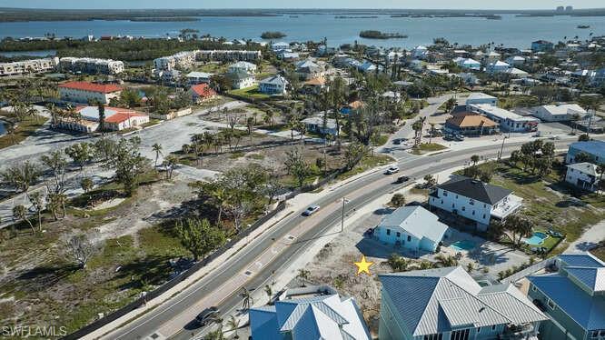 Birds eye view of property with a water view
