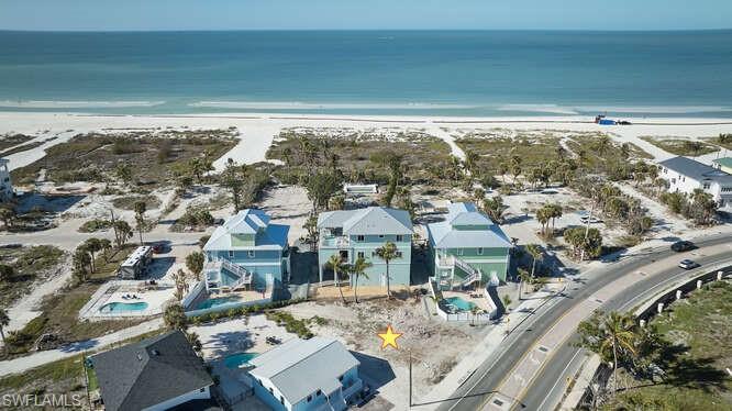 Bird's eye view with a water view and a view of the beach