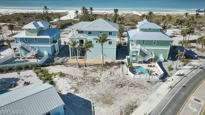 Drone / aerial view with a water view and a view of the beach
