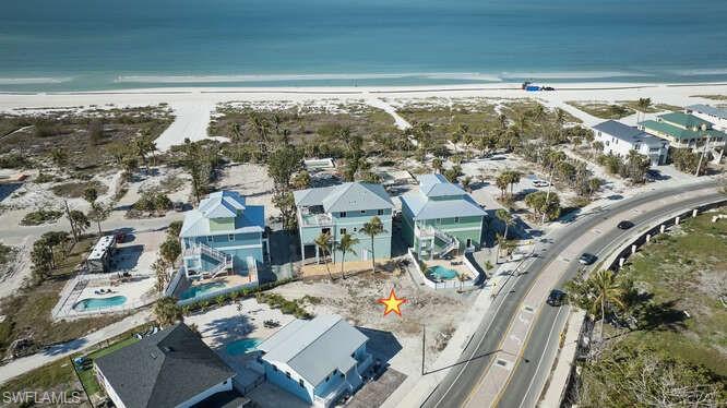 Drone / aerial view with a water view and a beach view