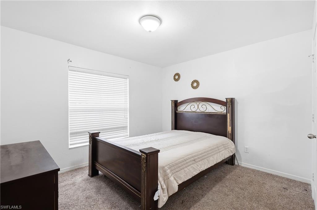 Carpeted bedroom with baseboards