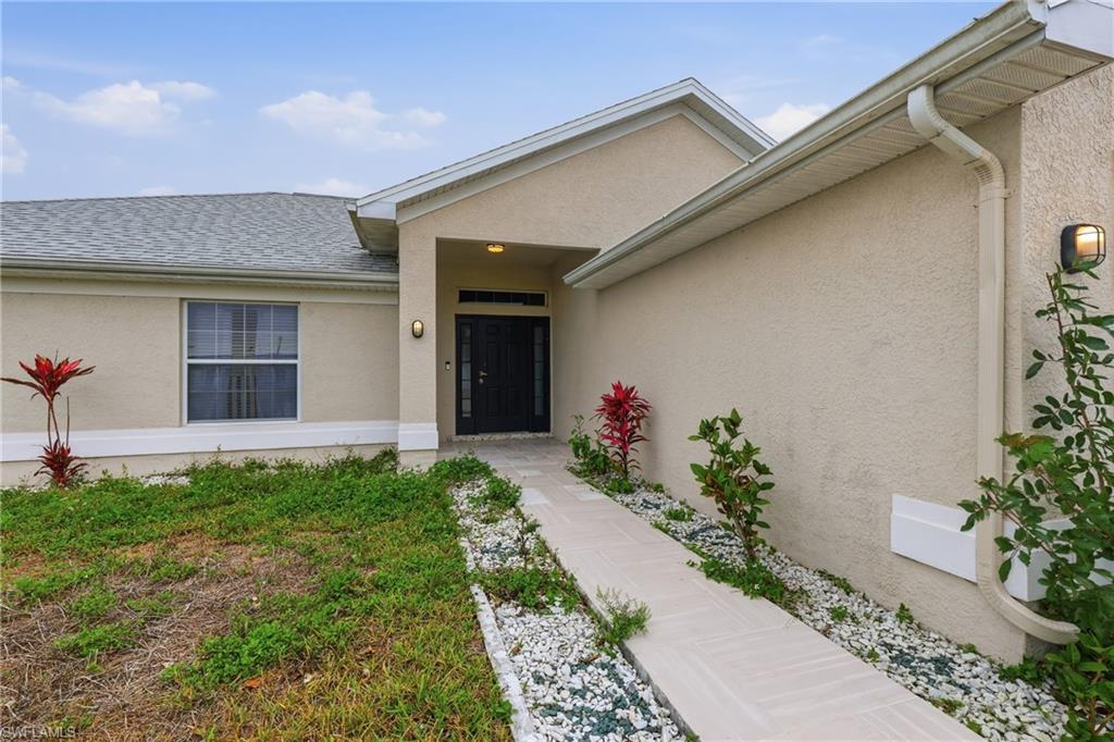 Property entrance with stucco siding