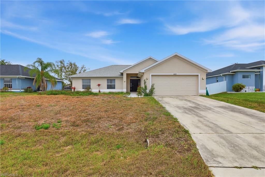 Single story home with a garage, stucco siding, and concrete driveway