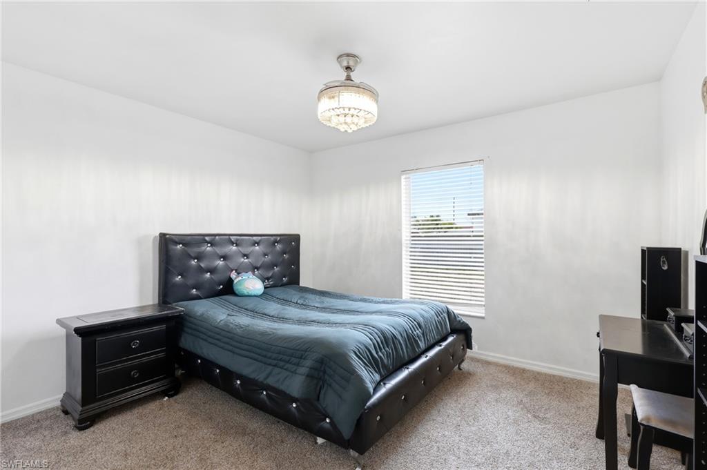 Carpeted bedroom featuring baseboards