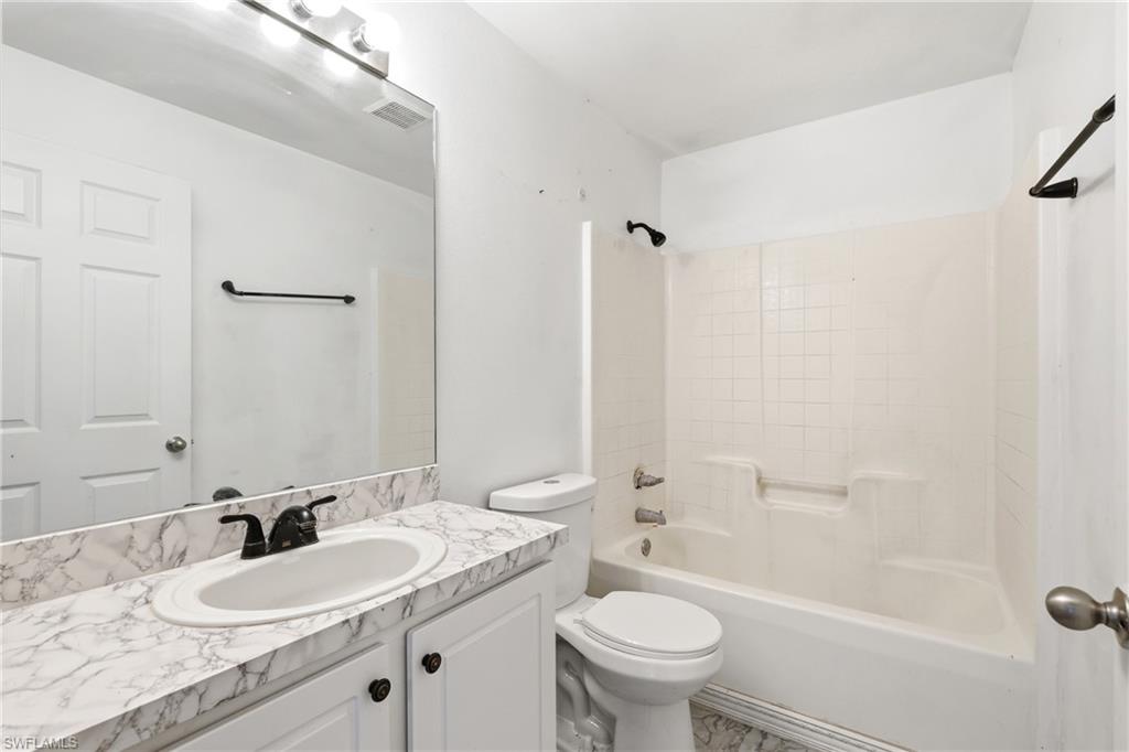 Bathroom with vanity and washtub / shower combination