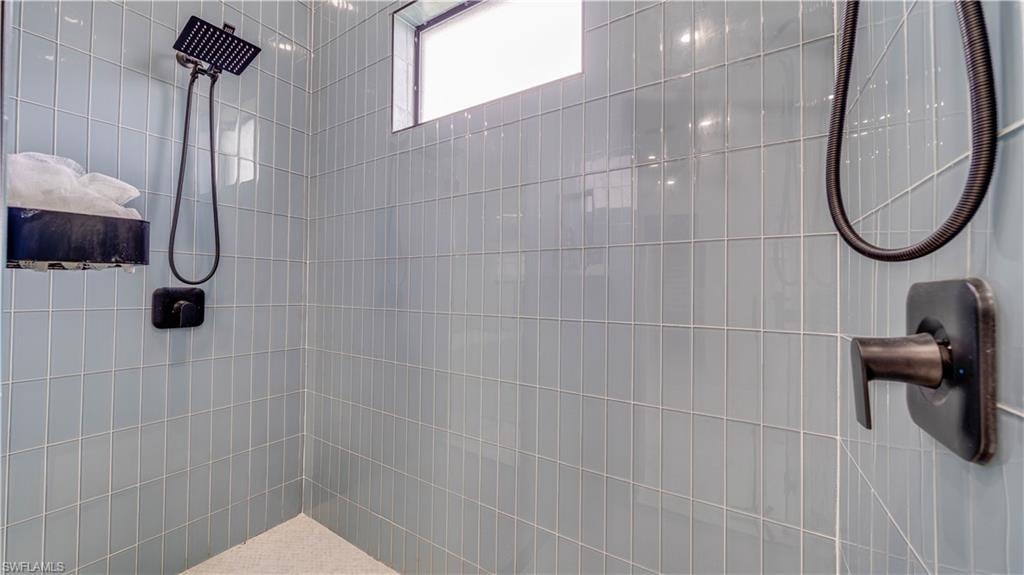 Primary bathroom walk thru shower with dual shower systems