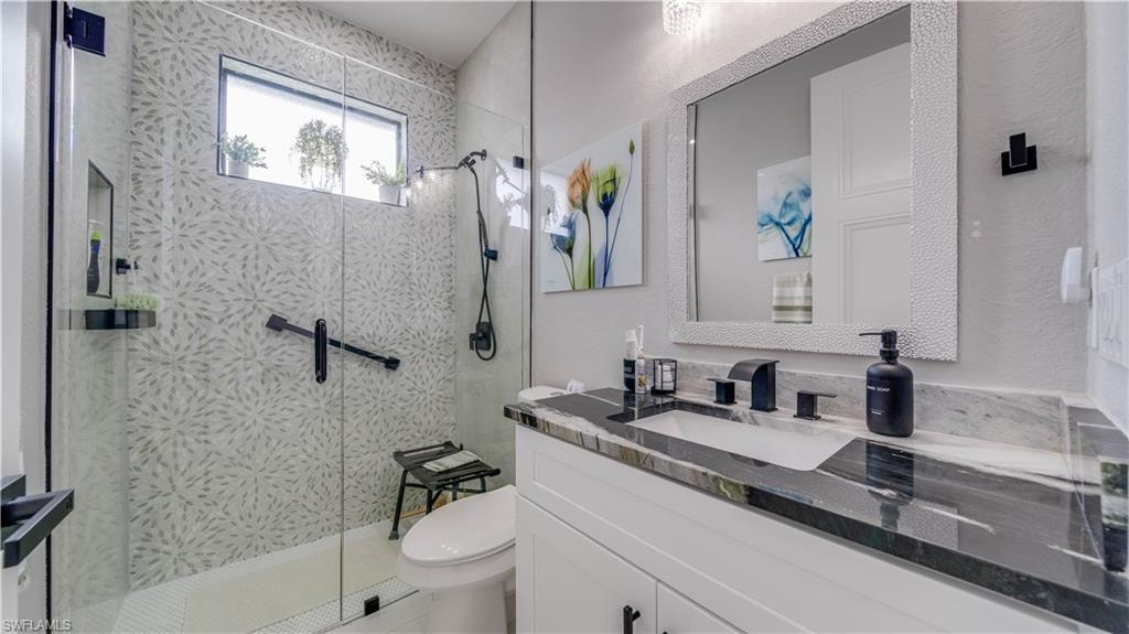 Guest Bathroom with granite topped vanity and tiled shower