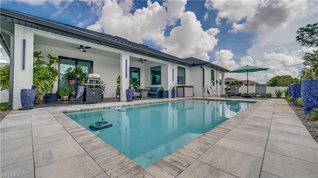 View of swimming pool featuring an outdoor lounge area, and area for grilling