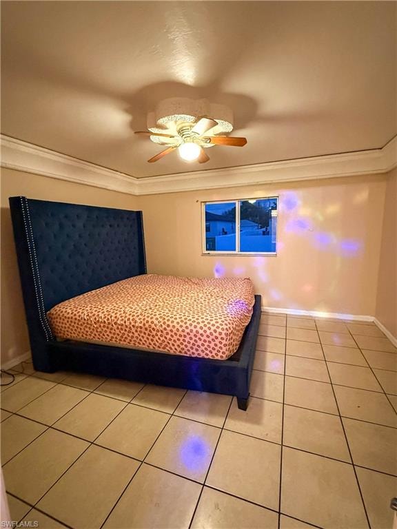 Bedroom with light tile patterned floors, a ceiling fan, and crown molding