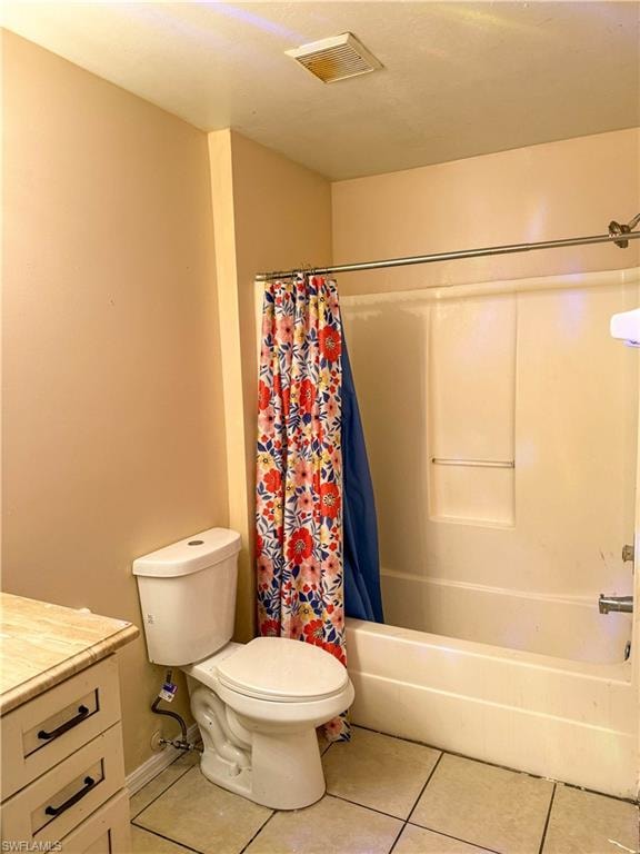 Bathroom featuring vanity, light tile patterned floors, and shower / bath combination with curtain