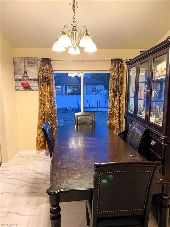 Dining area with suspended lighting and baseboards