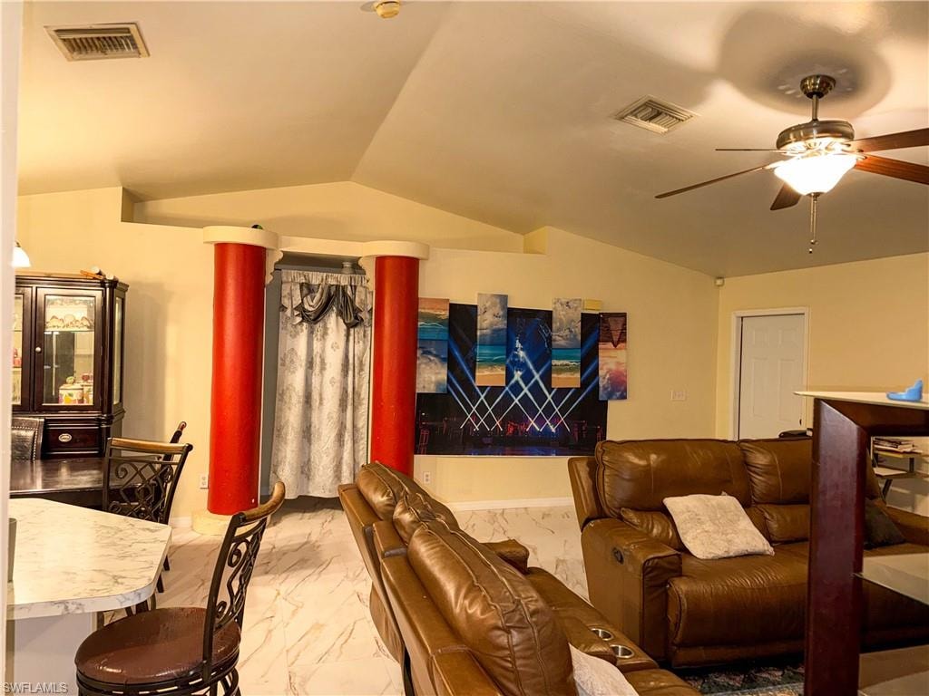 Home theater room with ceiling fan and lofted ceiling