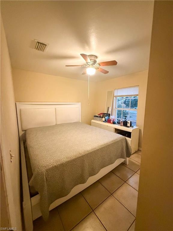 Bedroom featuring light tile patterned floors and a ceiling fan