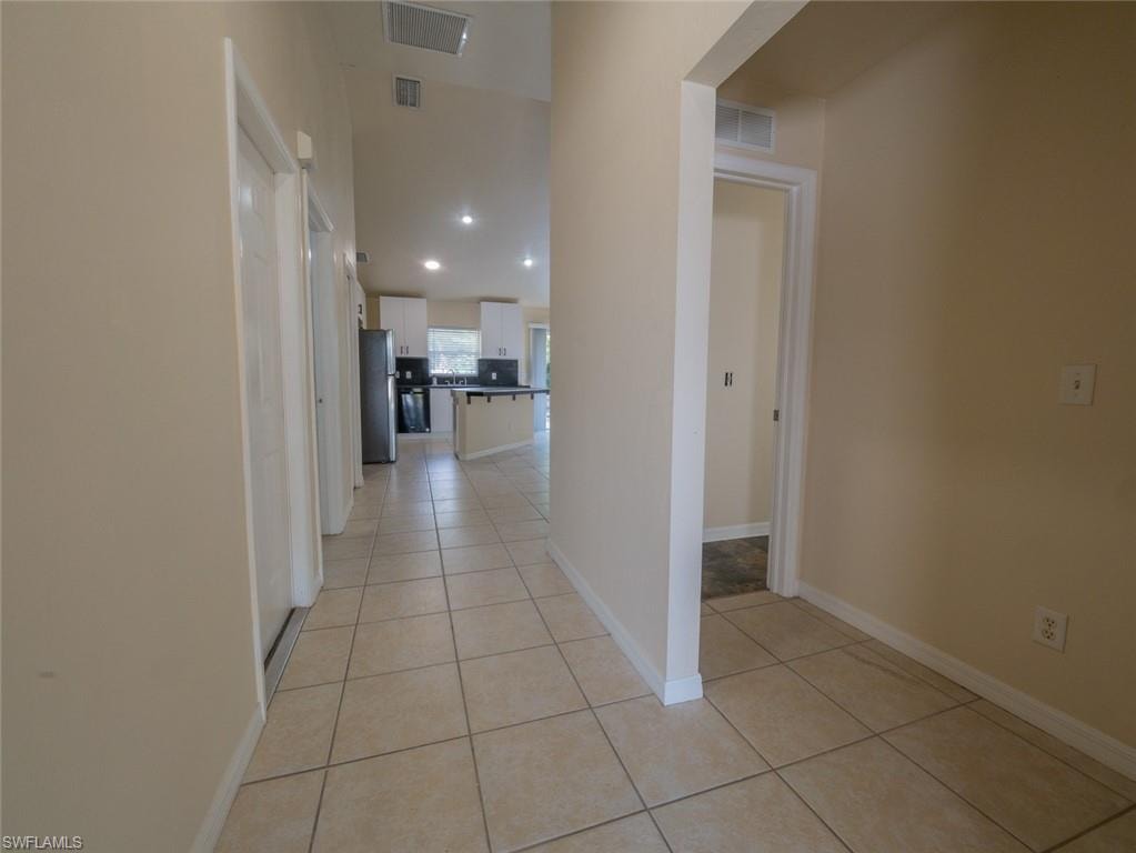 Hallway featuring light tile patterned flooring