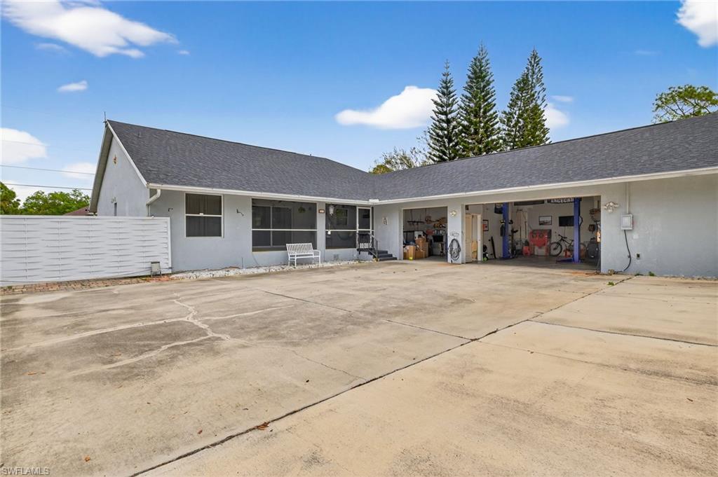 Single story home featuring concrete driveway, stucco siding, a garage, and a shingled roof