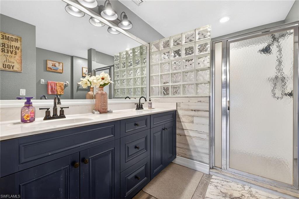 Primary Bathroom with double vanity and a stall shower