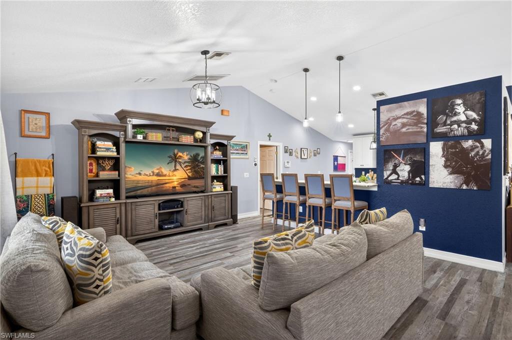 Living area featuring wood finished floors and a high ceiling