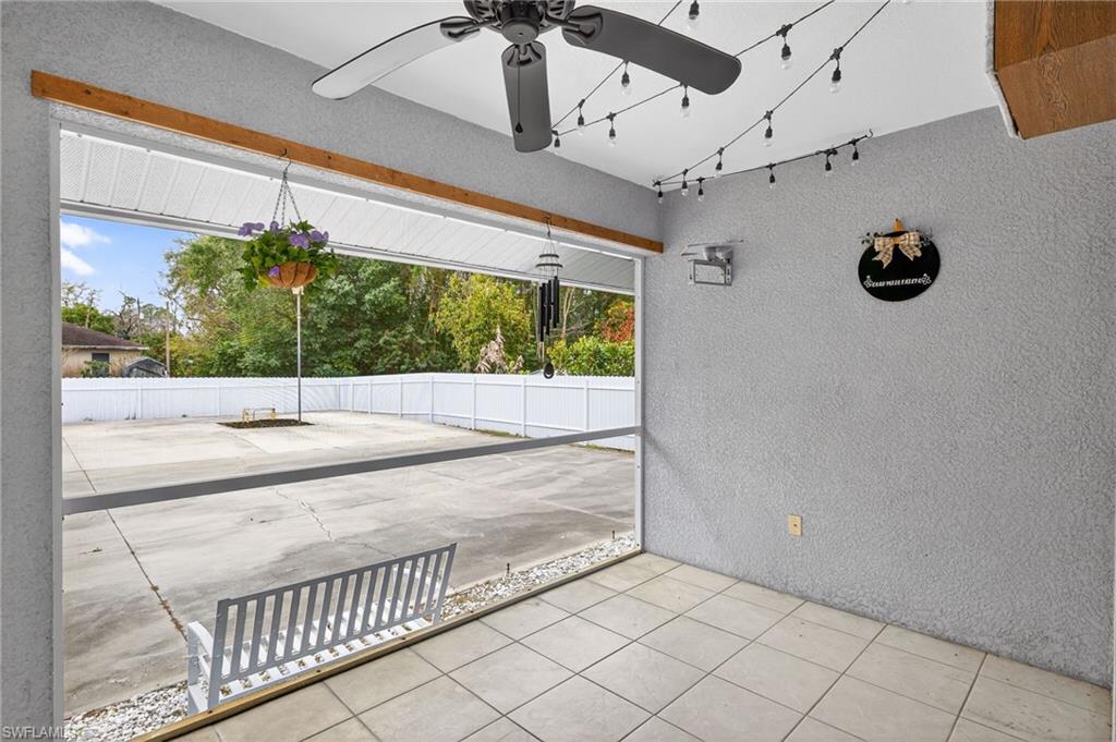 Fenced backyard featuring a patio area and ceiling fan