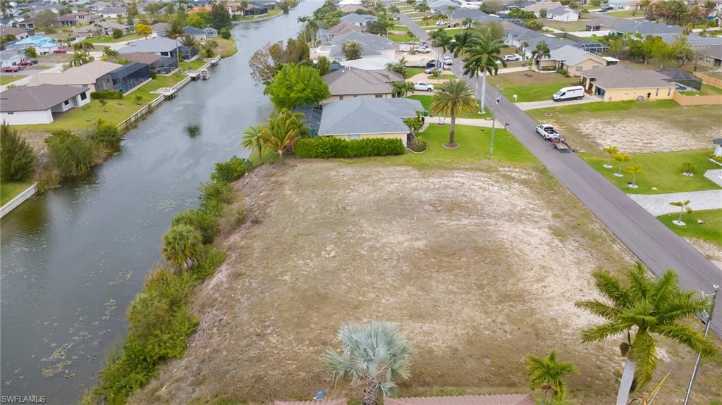 Aerial perspective of suburban area featuring a large body of water