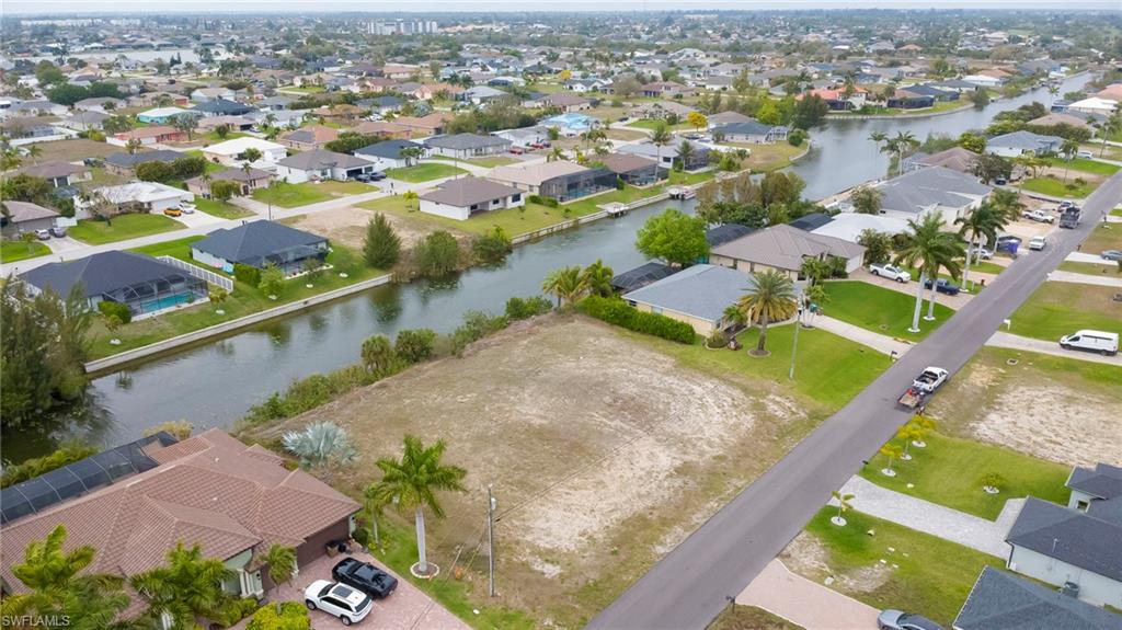 Aerial perspective of suburban area with a large body of water