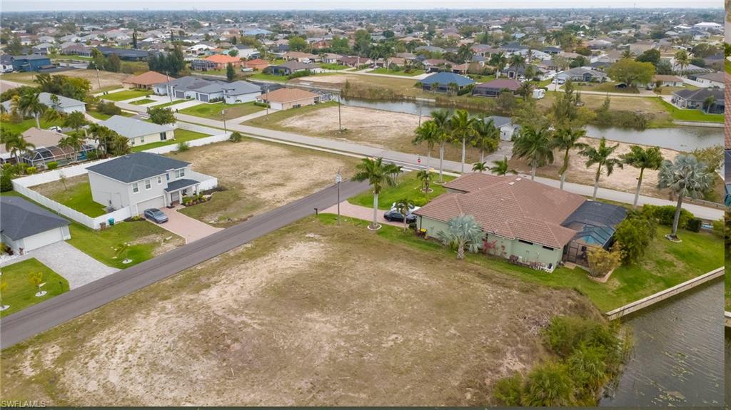 Aerial perspective of suburban area featuring a large body of water