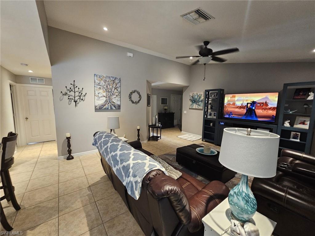 Living area featuring light tile patterned floors, recessed lighting, and ceiling fan