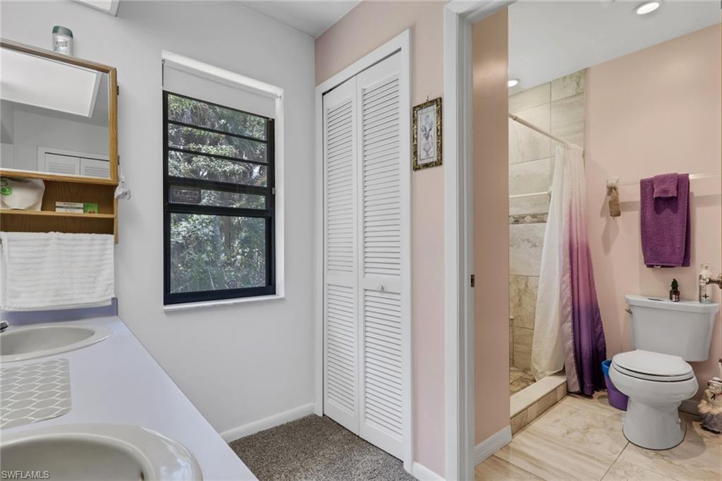 Master bathroom features dual sinks, linen closet, spacious tile shower.