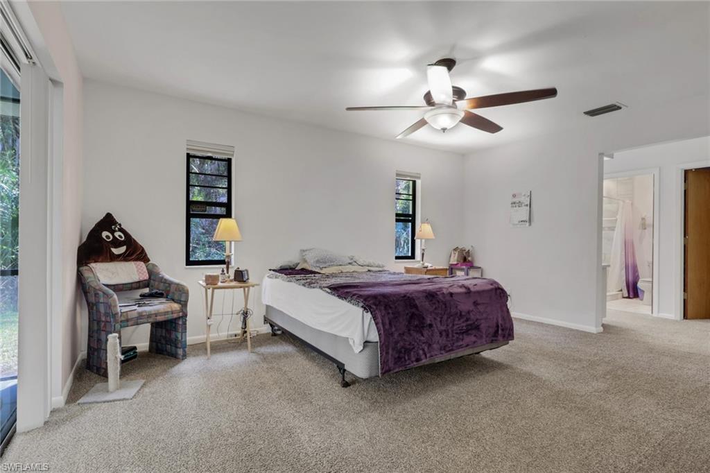 Spacious master bedroom with access to the lanai, two closets, dual sinks, tiled shower.