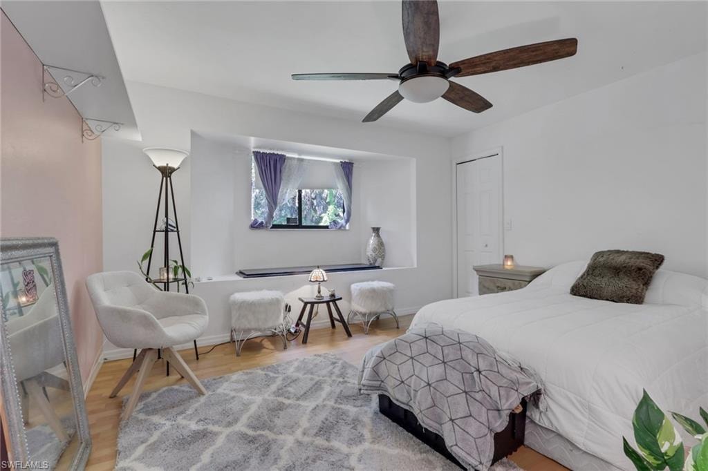 Spacious bedroom with window seating and a walk in closet.