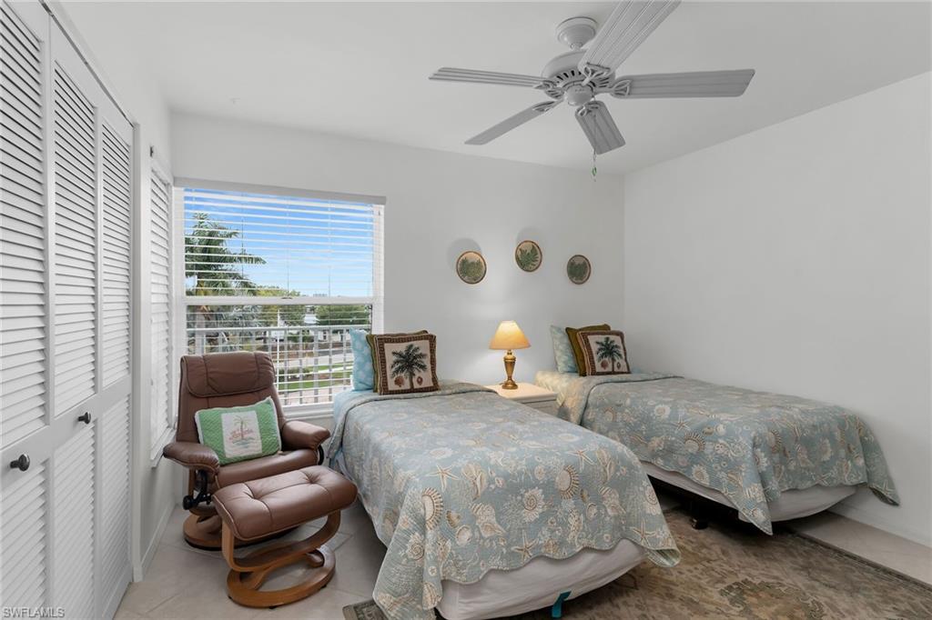 Tiled bedroom featuring a closet and ceiling fan