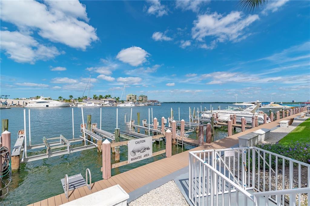 Dock area featuring boat lift and a water view