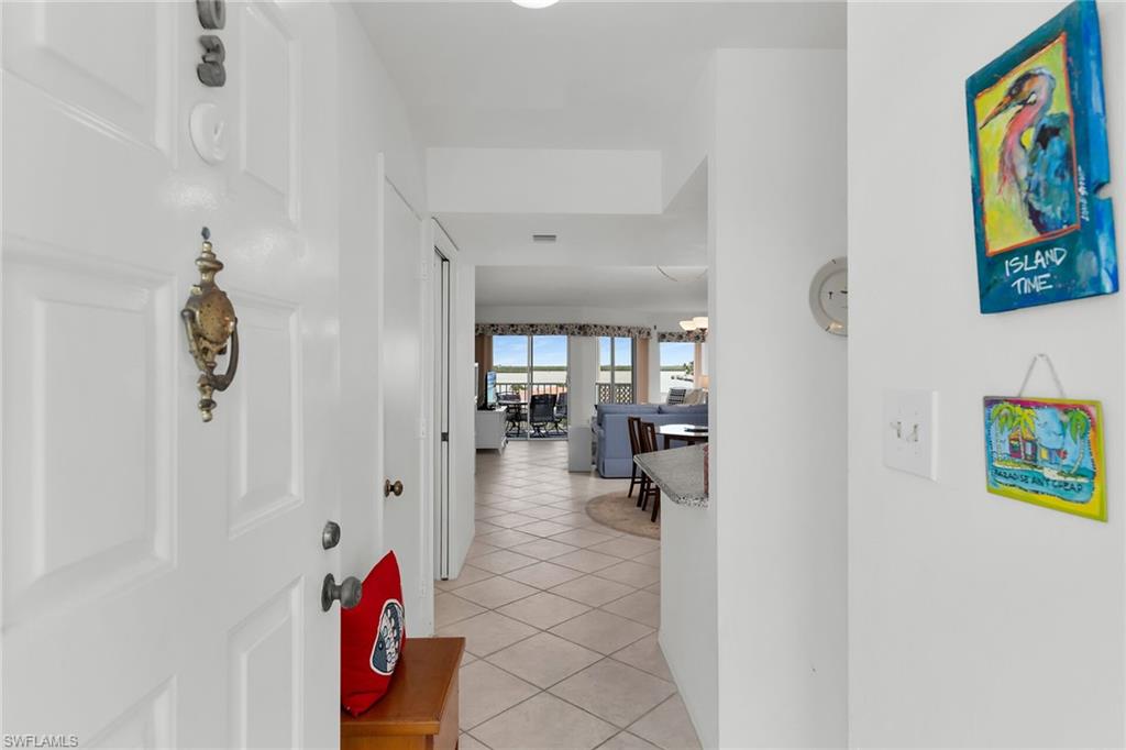 Hallway featuring light tile patterned flooring