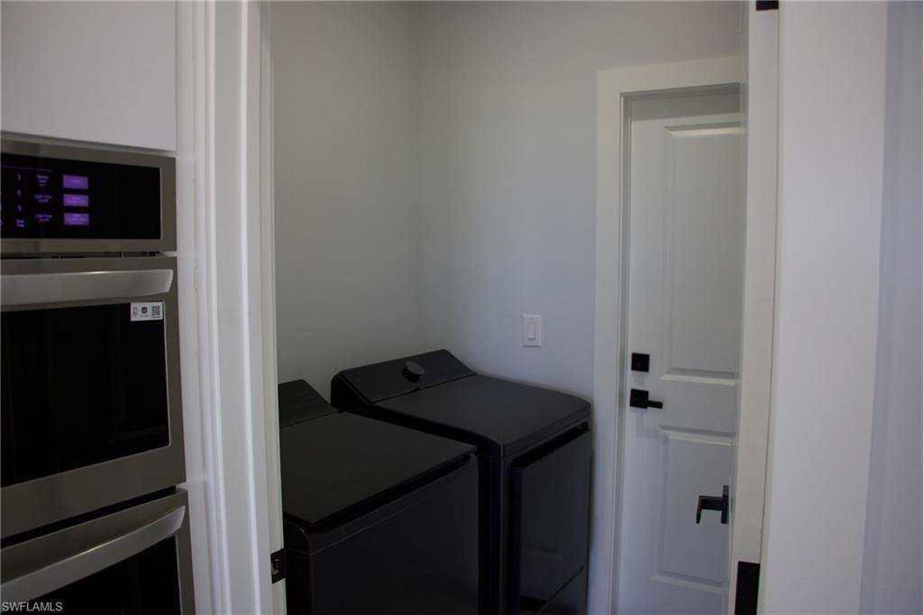 Laundry room featuring washer and clothes dryer