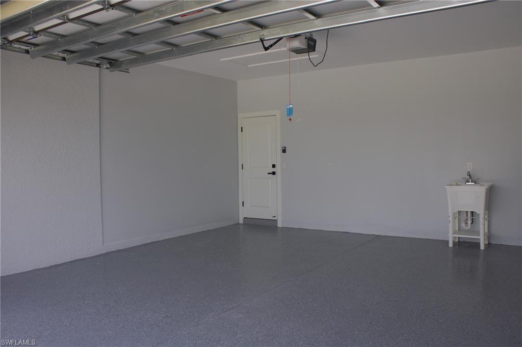 Garage featuring a sink and a garage door opener