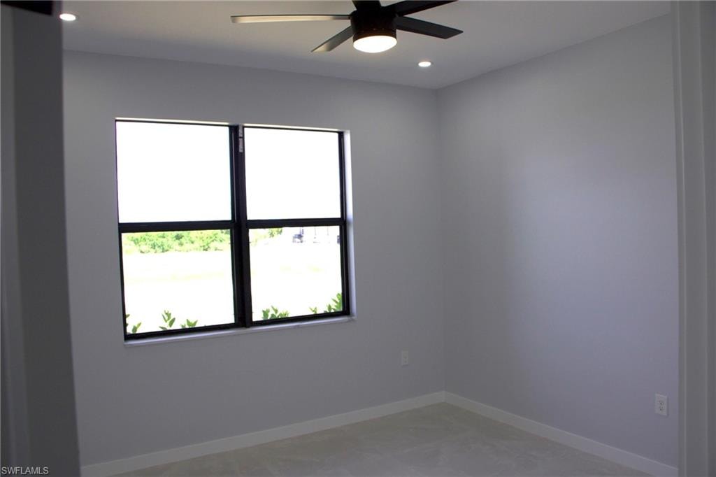 Spare room with ceiling fan, plenty of natural light, and recessed lighting