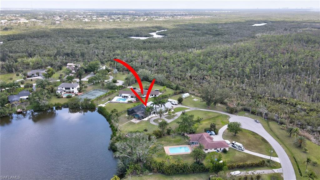 Aerial view featuring a water view and a forest view