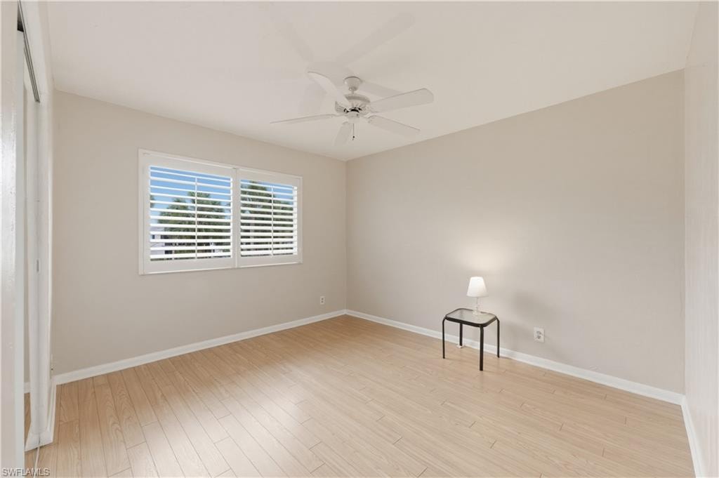 Spare Bedroom with light wood-style floors and a ceiling fan