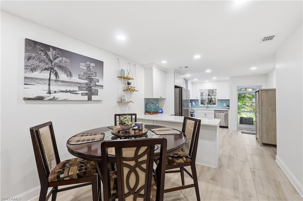 Dining space with recessed lighting and light wood-style floors