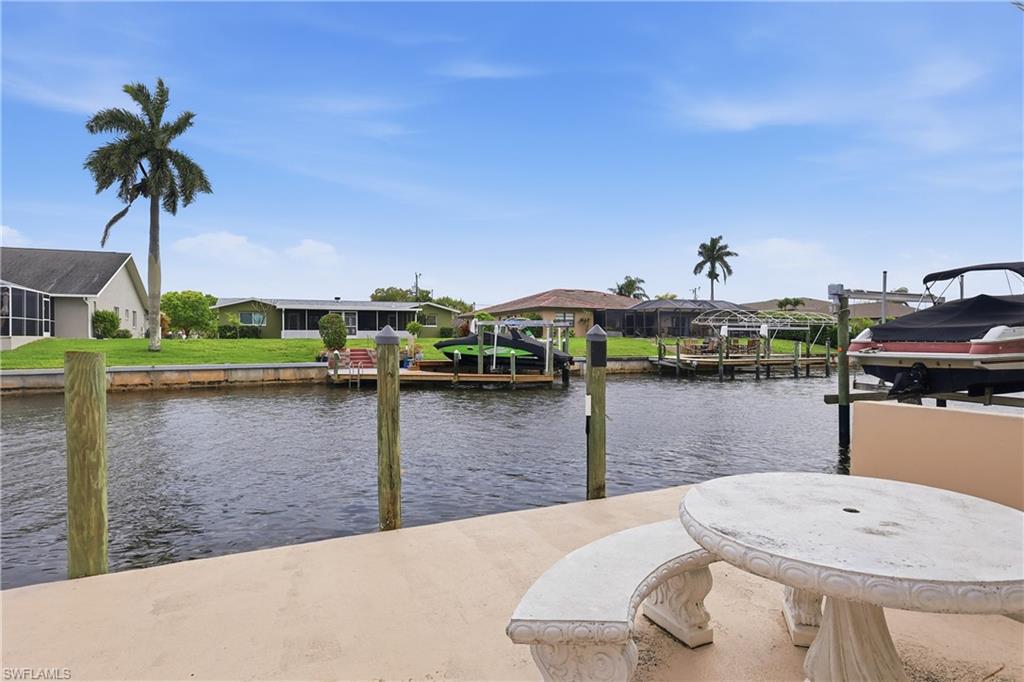 Dock with a water view, boat lift, and a residential view