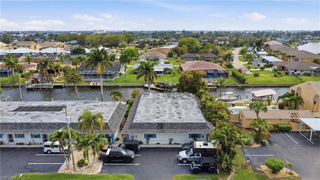Aerial perspective of suburban area featuring a nearby body of water