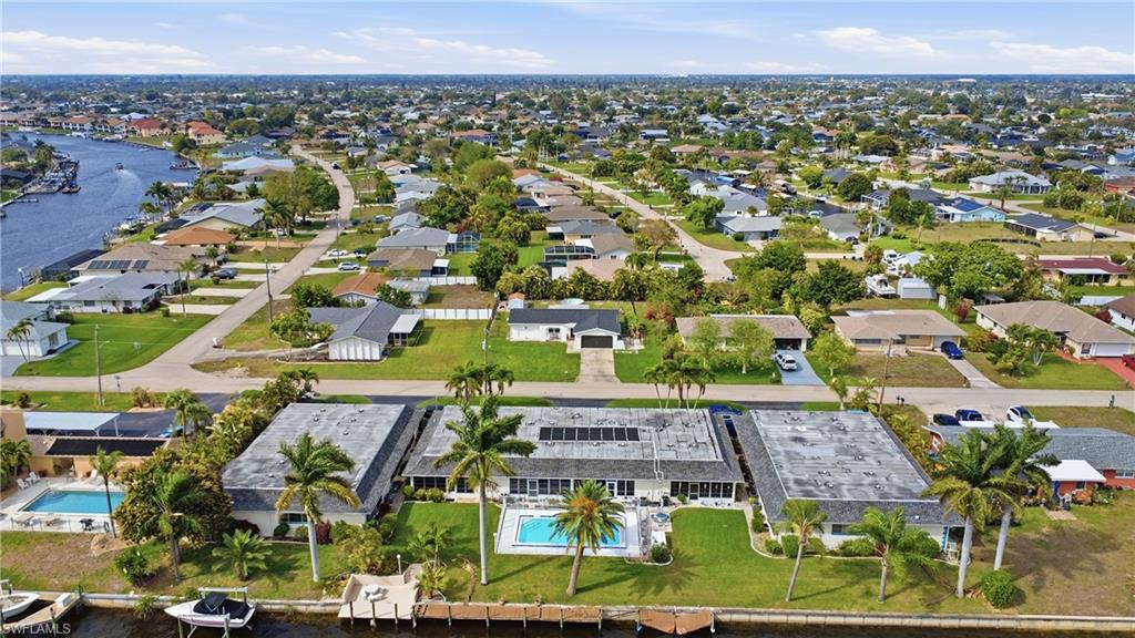 Aerial view of property and surrounding area with nearby suburban area