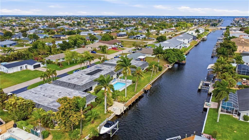 Aerial perspective of suburban area featuring a nearby body of water