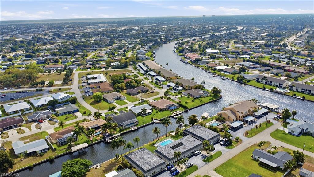 Aerial view of property and surrounding area and nearby suburban area and views of the Caloosahatchee River