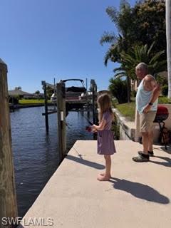 Dock featuring boat lift and a water view