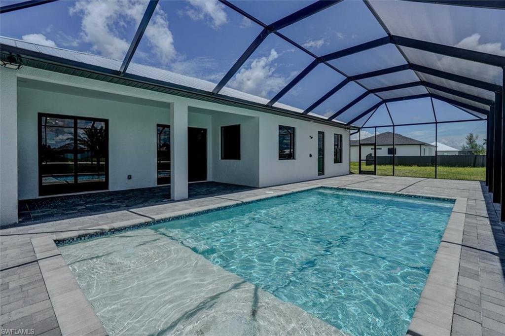 View of swimming pool with a lanai and a patio