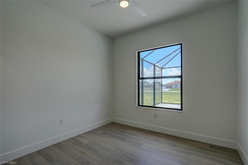 Spare room with ceiling fan and hardwood / wood-style floors