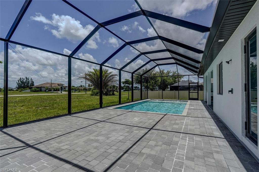 View of swimming pool with a lawn, a patio, and a lanai