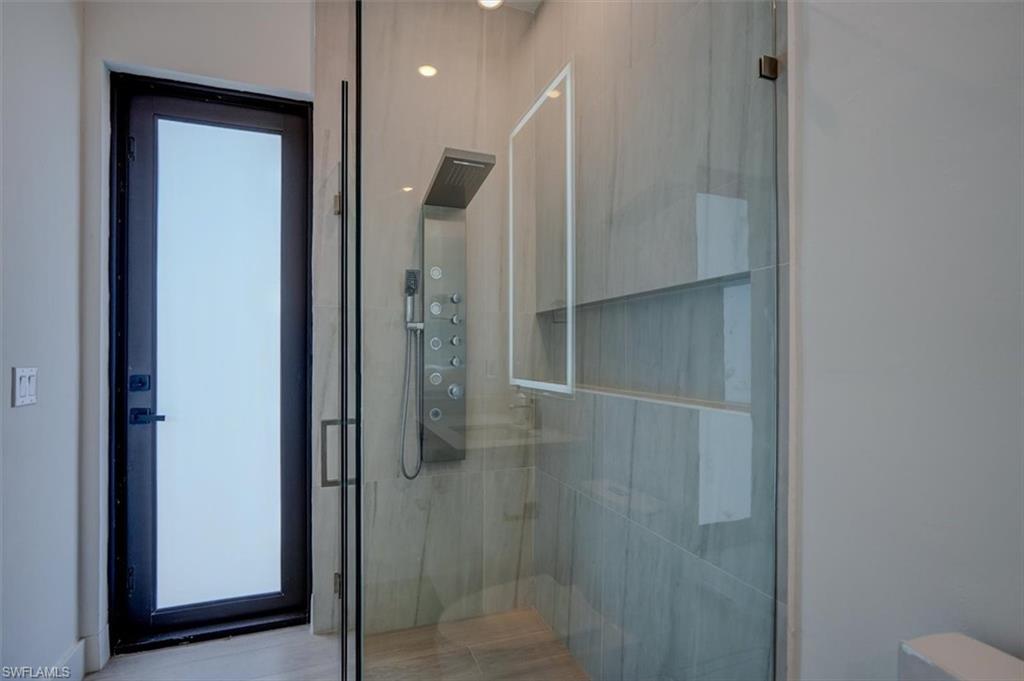Bathroom featuring a shower with door