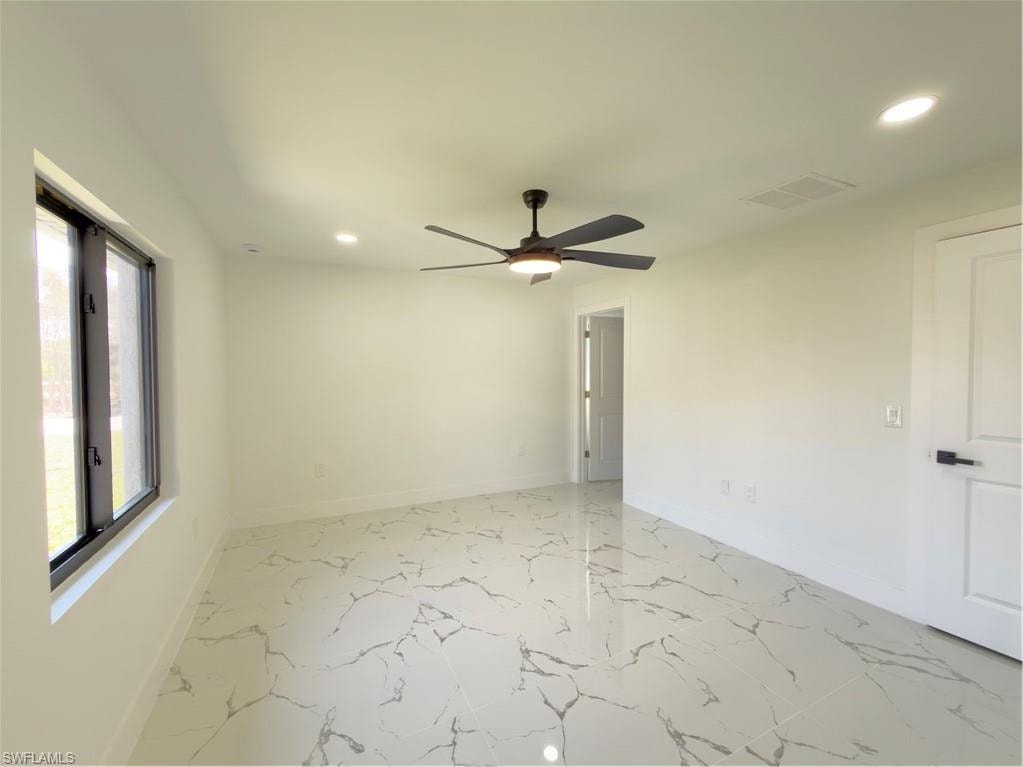 Unfurnished room featuring recessed lighting, ceiling fan, and light marble finish flooring